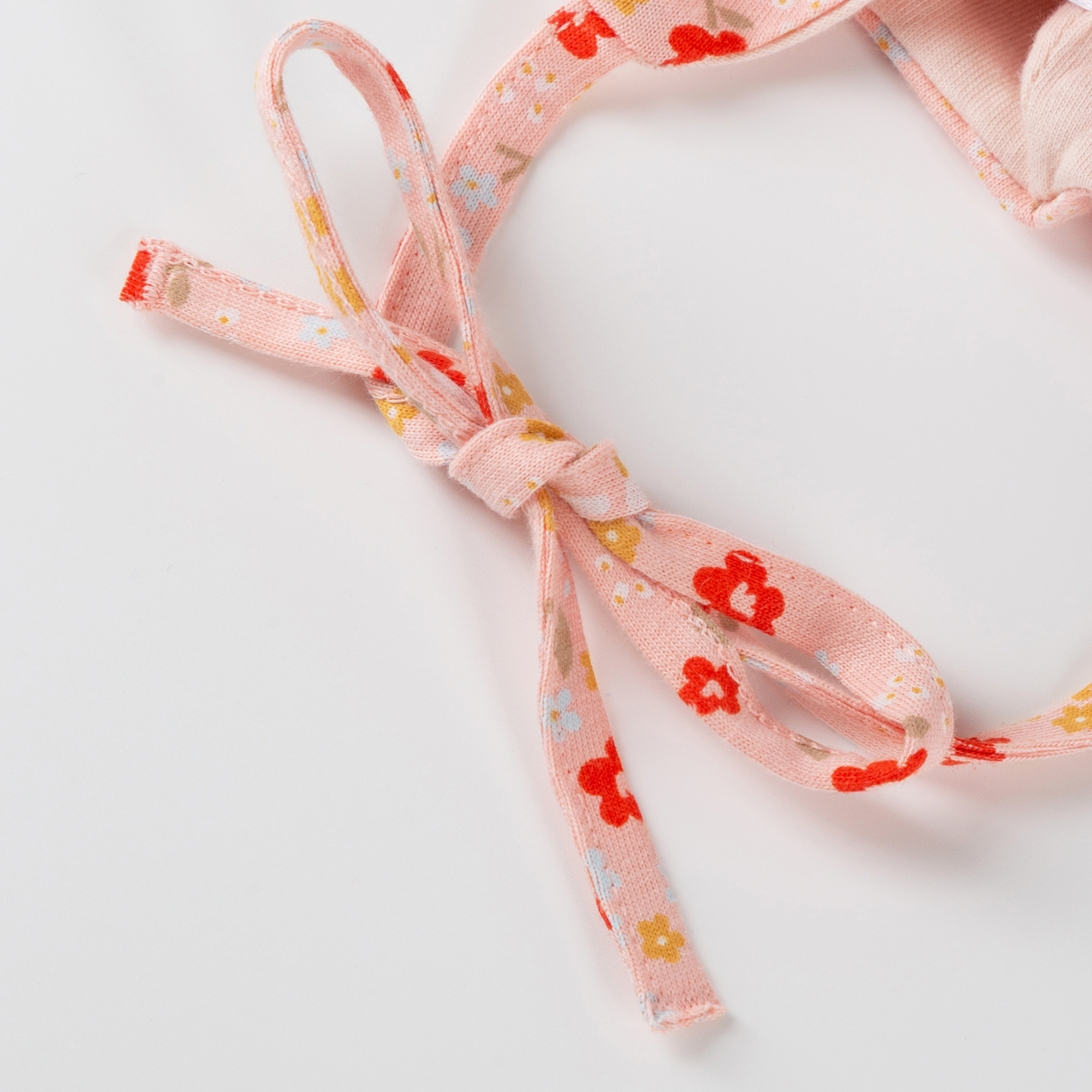 Flowery newborn baby hat with ties, lined